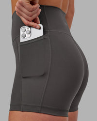Woman wearing Fusion Ultra High-Rise 4" Short Pockets - Dark Storm | Model:Keisha | Size:S | Thumbnail Index: 4