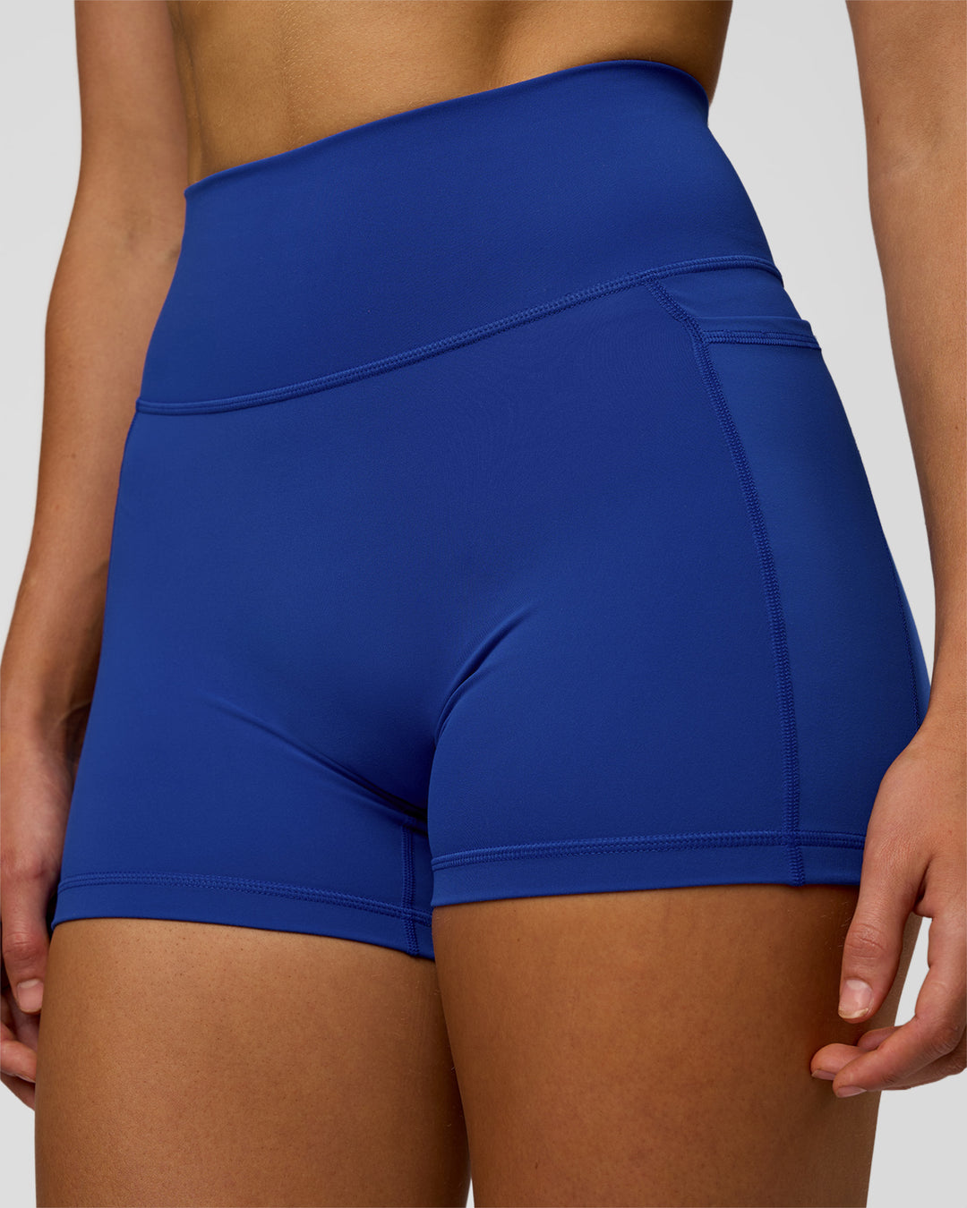 Woman wearing Fusion Ultra High-Rise 4" Short Pockets - Electric Indigo | Model:Evie | Size:S - view 7