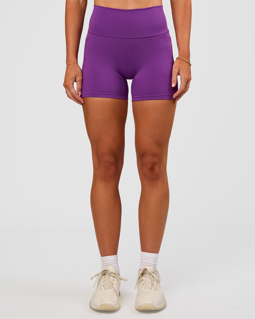 Woman wearing Fusion Ultra High-Rise 4" Short Pockets - Fresh Purple | Set:true | Angle:front | Model:Emelia | Size:S - view 8