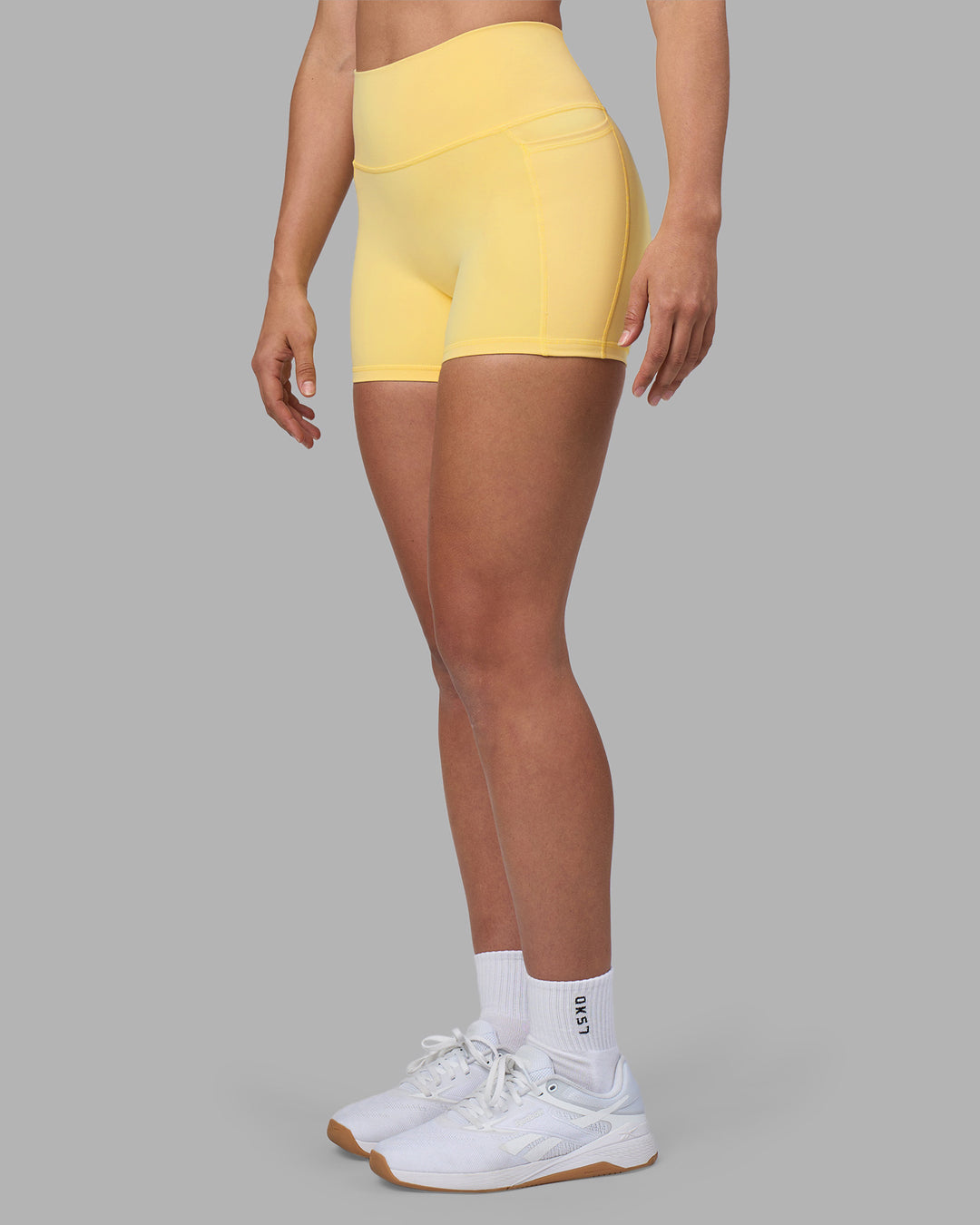 Woman wearing Fusion Ultra High-Rise 4" Short Pockets - Lemon | Model:Sophie | Size:S - view 7