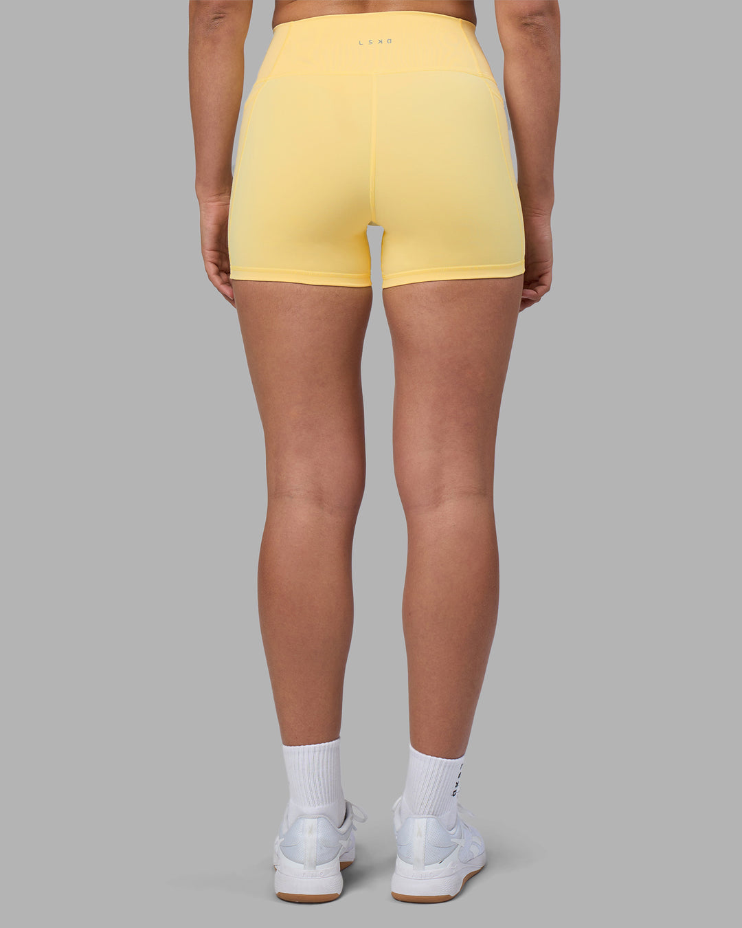 Woman wearing Fusion Ultra High-Rise 4" Short Pockets - Lemon | Model:Sophie | Size:S - view 4