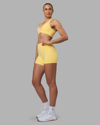 Woman wearing Fusion Ultra High-Rise 4" Short Pockets - Lemon | Model:Sophie | Size:S | Thumbnail Index: 1