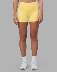 Woman wearing Fusion Ultra High-Rise 4" Short Pockets - Lemon | Model:Sophie | Size:S | Thumbnail Index: 0