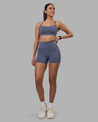 Woman wearing Fusion Ultra High-Rise 4" Short Pockets - Night Shadow | Model:Rhiley | Size:S | Thumbnail Index: 0
