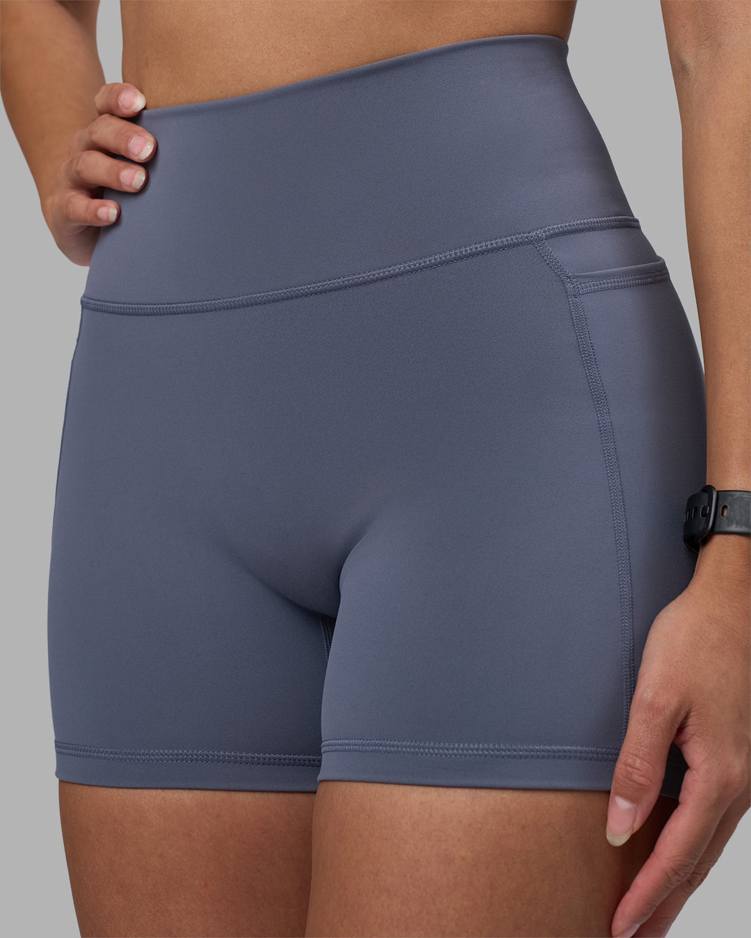 Woman wearing Fusion Ultra High-Rise 4" Short Pockets - Night Shadow | Model:Rhiley | Size:S - view 6