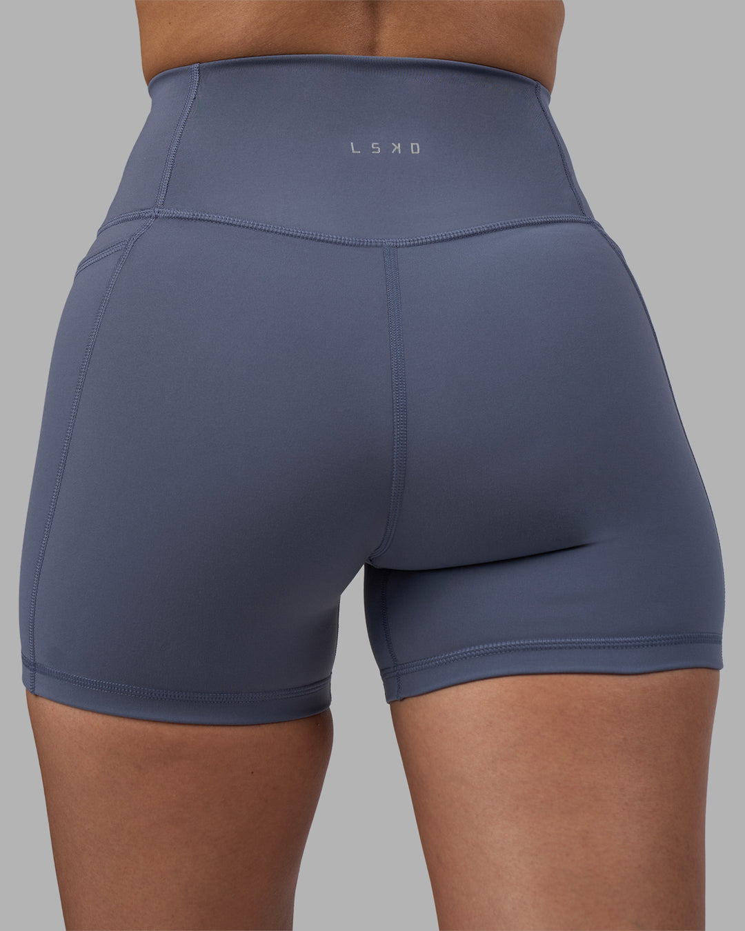 Woman wearing Fusion Ultra High-Rise 4" Short Pockets - Night Shadow | Model:Rhiley | Size:S - view 8