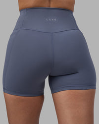 Woman wearing Fusion Ultra High-Rise 4" Short Pockets - Night Shadow | Model:Rhiley | Size:S | Thumbnail Index: 7