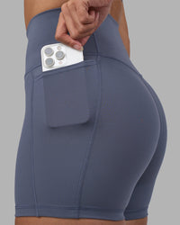 Woman wearing Fusion Ultra High-Rise 4" Short Pockets - Night Shadow | Set:true | Angle:closeup | Model:Rhiley | Size:S | Thumbnail Index: 1