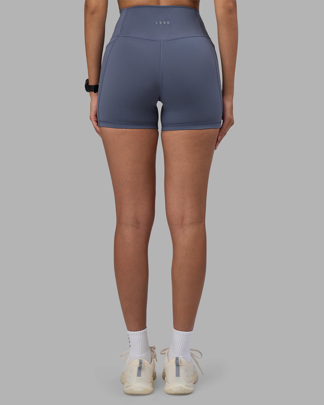 Woman wearing Fusion Ultra High-Rise 4" Short Pockets - Night Shadow | Set:true | Angle:back | Model:Rhiley | Size:S - view 4