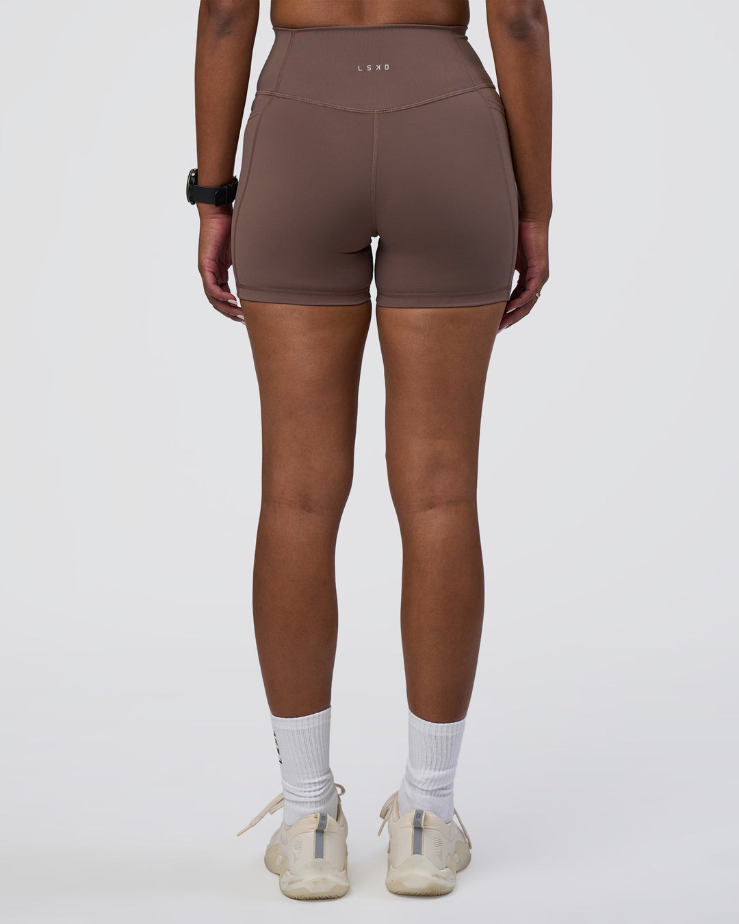 Woman wearing Fusion Ultra High-Rise 4" Short Pockets - Peppercorn | Set:true | Angle:back | Model:Rica | Size:S - view 3