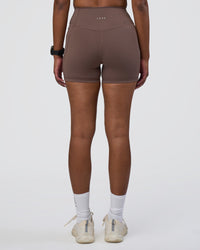 Woman wearing Fusion Ultra High-Rise 4" Short Pockets - Peppercorn | Set:true | Angle:back | Model:Rica | Size:S | Thumbnail Index: 2
