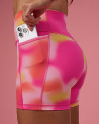 Woman wearing Fusion Ultra High-Rise 4" Short Pockets - Pink Glow Print | Set:true | Angle:closeup | Model:Hannah | Size:S | Thumbnail Index: 1