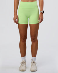 Woman wearing Fusion Ultra High-Rise 4" Short Pockets - Solar Lime | Set:true | Angle:front | Model:Emelia | Size:S | Thumbnail Index: 0