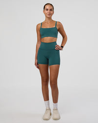 Woman wearing Fusion Ultra High-Rise 4" Short Pockets - Transformative Teal | Model:Myrte | Size:S | Thumbnail Index: 1