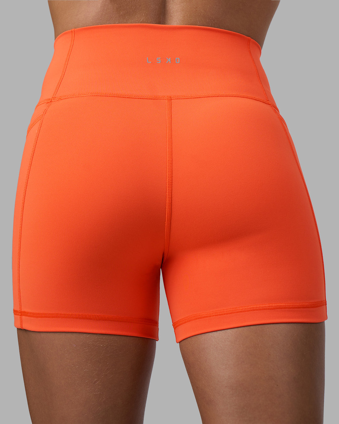 Woman wearing Fusion Ultra High-Rise 4" Short Pockets - Ultra Orange | Model:Katie | Size:S - view 4