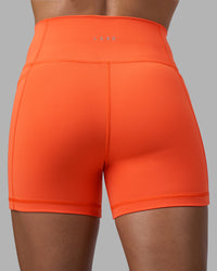 Woman wearing Fusion Ultra High-Rise 4" Short Pockets - Ultra Orange | Model:Katie | Size:S | Thumbnail Index: 3