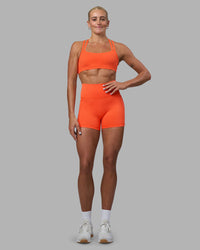 Woman wearing Fusion Ultra High-Rise 4" Short Pockets - Ultra Orange | Model:Katie | Size:S | Thumbnail Index: 1