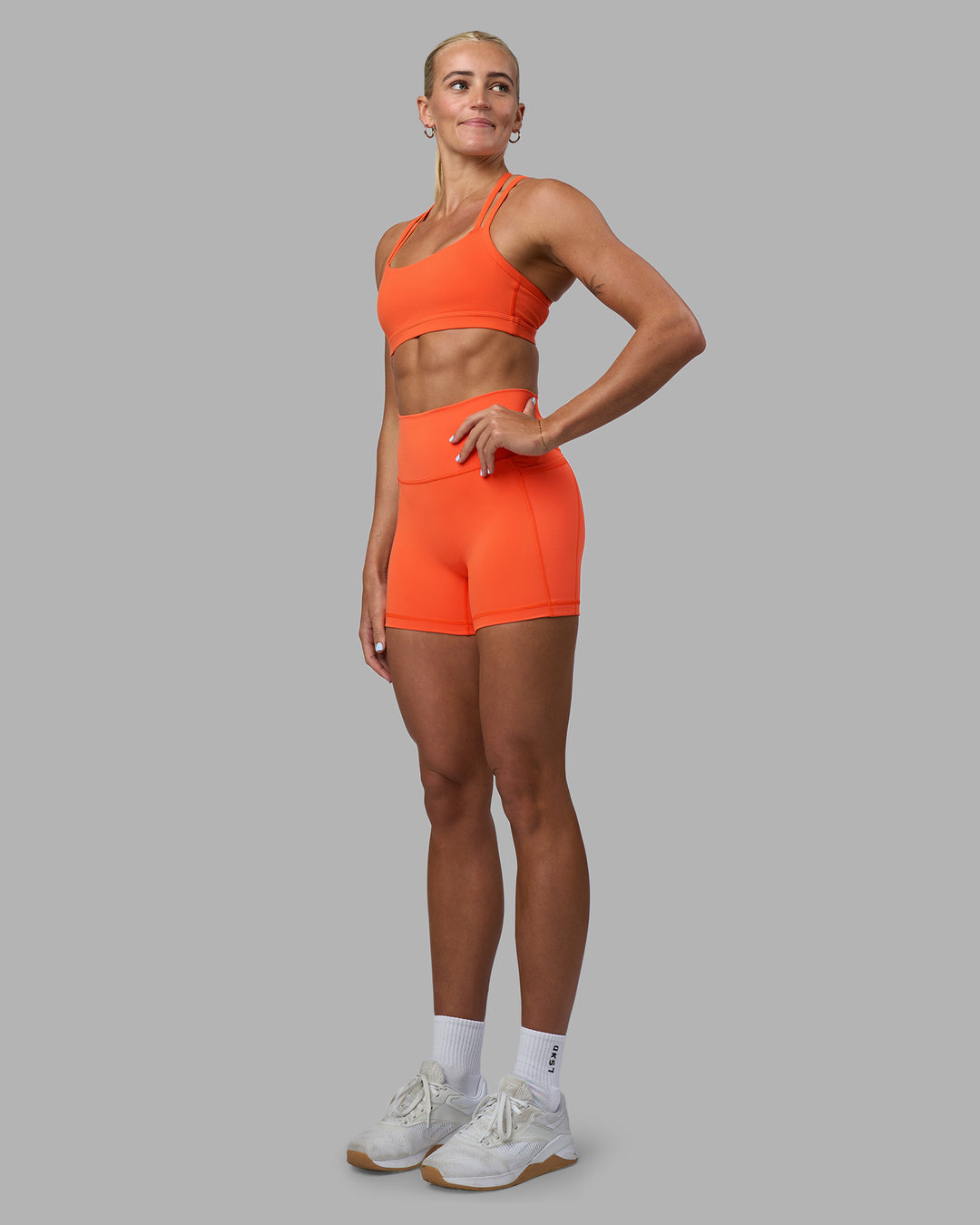 Woman wearing Fusion Ultra High-Rise 4" Short Pockets - Ultra Orange | Model:Katie | Size:S - view 5