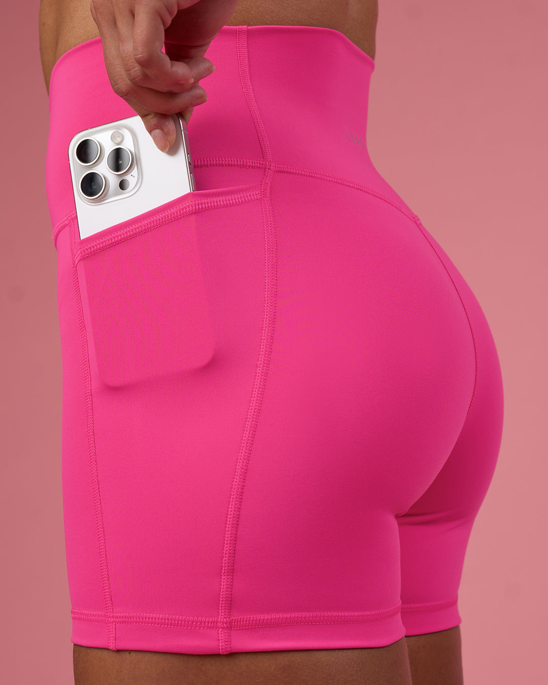 Woman wearing Fusion Ultra High-Rise 4" Short Pockets - Ultra Pink | Set:true | Angle:closeup | Model:Hannah | Size:S - view 2