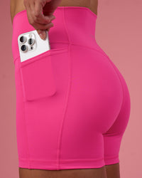 Woman wearing Fusion Ultra High-Rise 4" Short Pockets - Ultra Pink | Set:true | Angle:closeup | Model:Hannah | Size:S | Thumbnail Index: 1