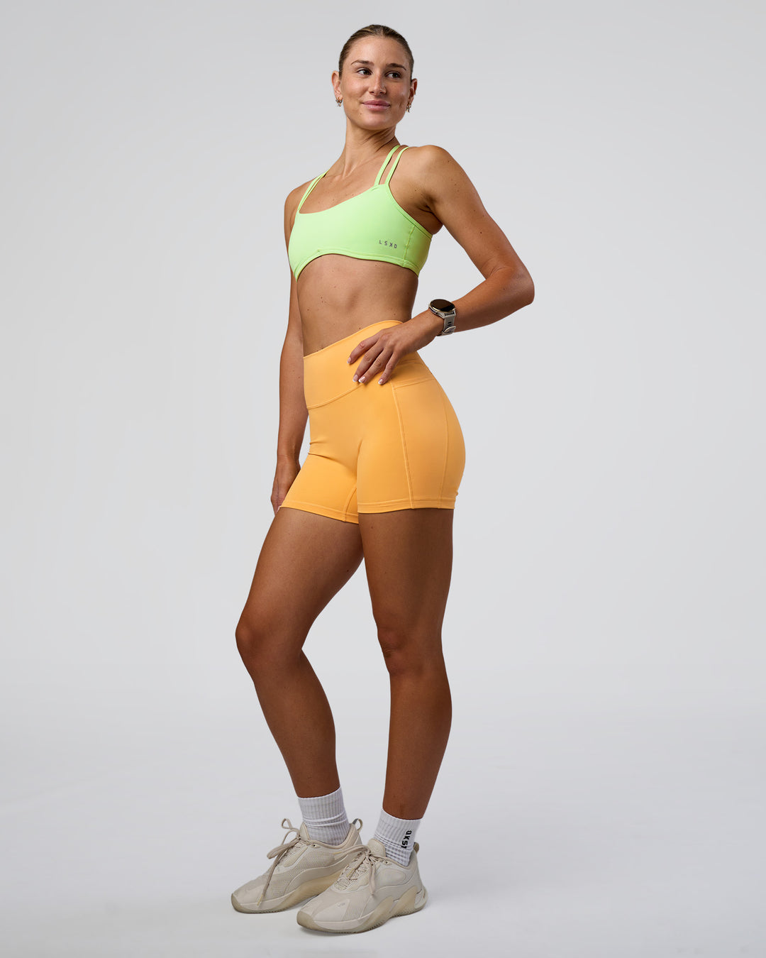 Woman wearing Fusion Ultra High-Rise 4" Short Pockets - Warm Apricot | Model:Emelia | Size:S - view 6