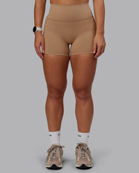 Woman wearing Fusion Ultra High-Rise 4" Short Pockets - Warm Smoke | Set:true | Angle:front | Model:Lyss | Size:S | Thumbnail Index: 5