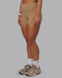 Woman wearing Fusion Ultra High-Rise 4" Short Pockets - Warm Smoke | Set:true | Angle:side | Model:Lyss | Size:S | Thumbnail Index: 2