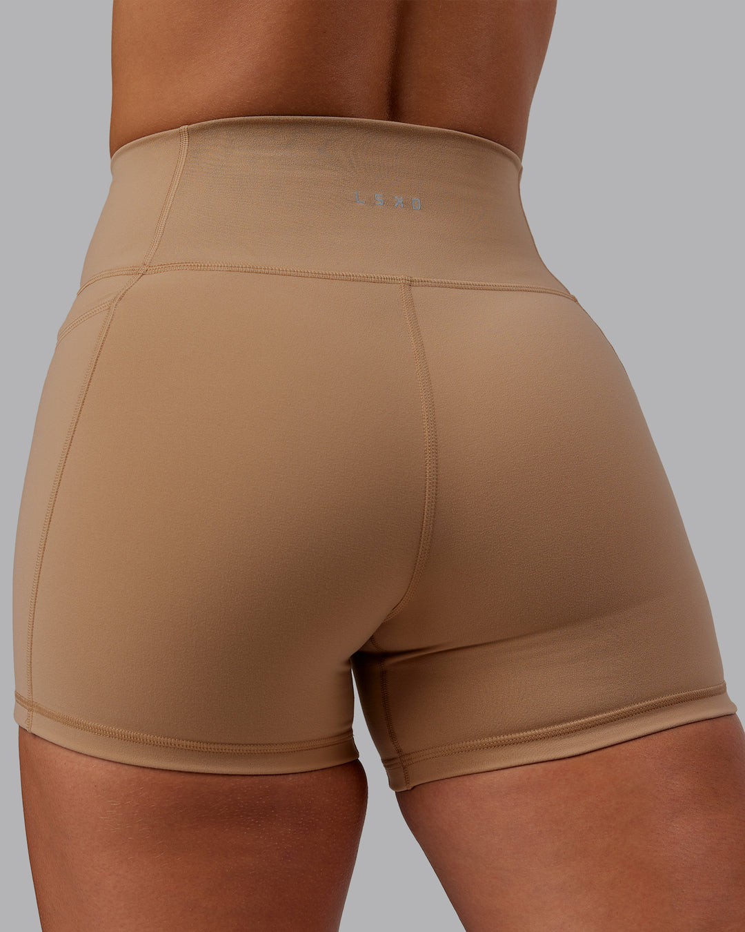 Woman wearing Fusion Ultra High-Rise 4" Short Pockets - Warm Smoke | Model:Lyss | Size:S - view 7
