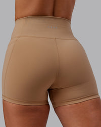 Woman wearing Fusion Ultra High-Rise 4" Short Pockets - Warm Smoke | Model:Lyss | Size:S | Thumbnail Index: 6