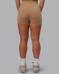 Woman wearing Fusion Ultra High-Rise 4" Short Pockets - Warm Smoke | Set:true | Angle:back | Model:Lyss | Size:S | Thumbnail Index: 3