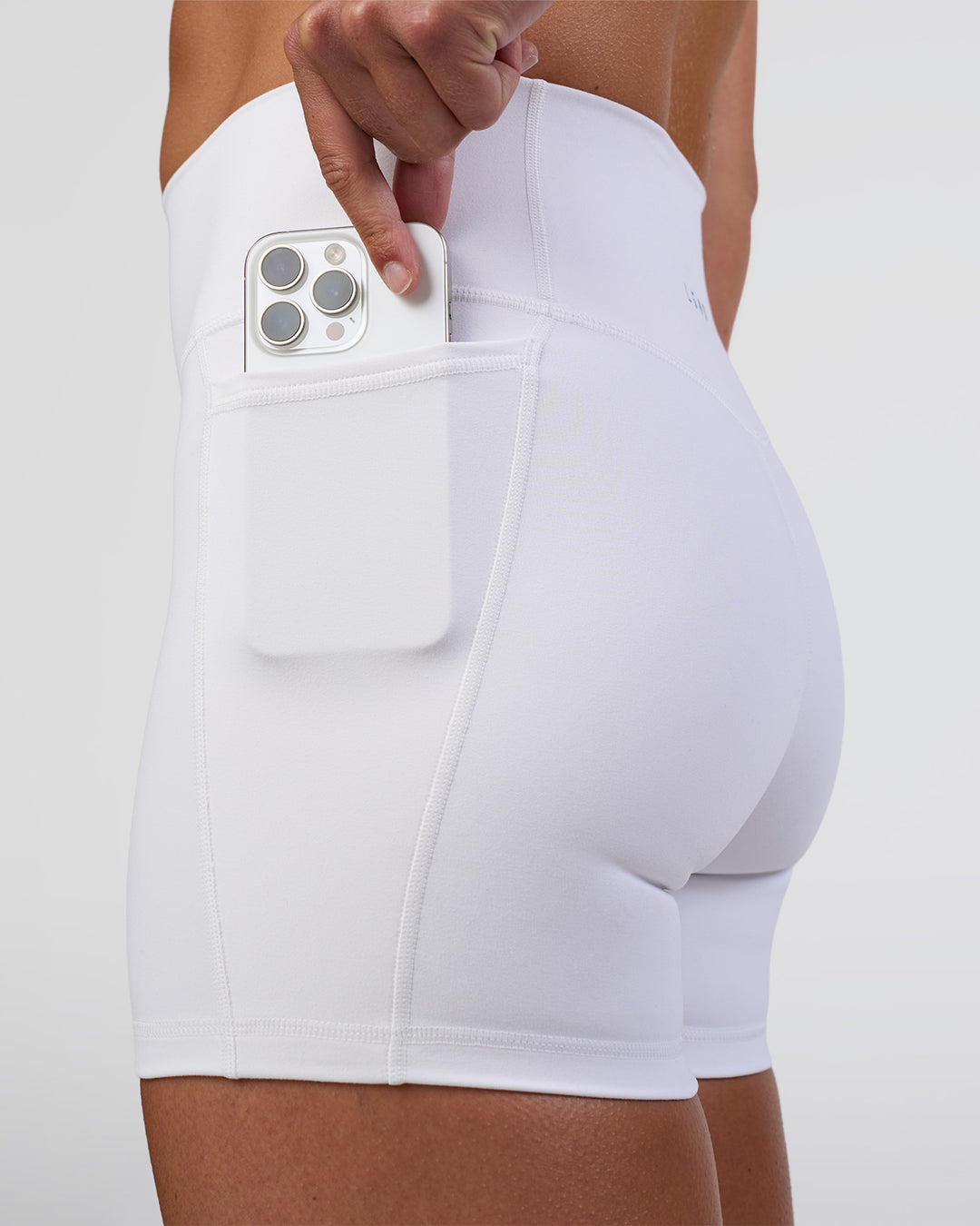 Woman wearing Fusion Ultra High-Rise 4" Short Pockets - White | Set:true | Angle:closeup | Model:Sav | Size:S - view 2