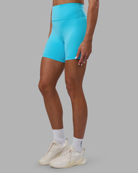 Woman wearing Fusion Ultra High-Rise 6" Short - Blue Atoll | Set:true | Angle:side | Model:Katie | Size:S | Thumbnail Index: 0