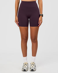 Woman wearing Fusion Ultra High-Rise 6" Short - Midnight Plum | Set:true | Angle:front | Model:Rhiley | Size:S | Thumbnail Index: 5