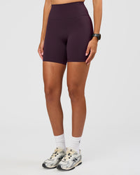 Woman wearing Fusion Ultra High-Rise 6" Short - Midnight Plum | Set:true | Angle:side | Model:Rhiley | Size:S | Thumbnail Index: 0