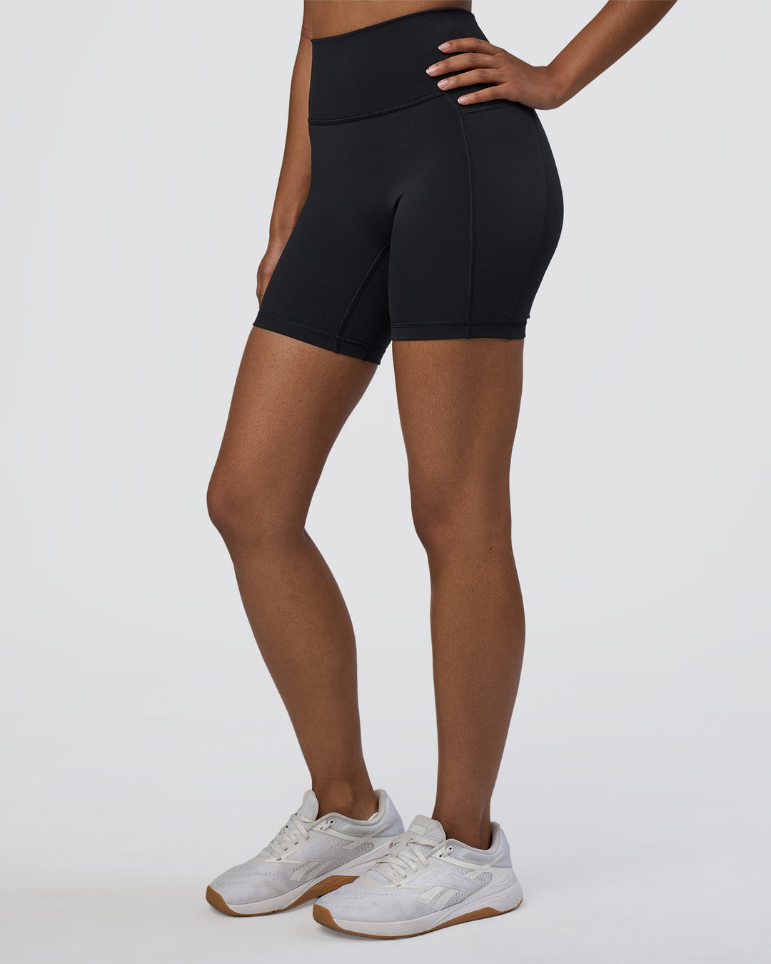 Woman wearing Fusion Ultra High-Rise 6" Short Pockets - Black | Set:true | Angle:side | Model:Jordan | Size:S - view 1