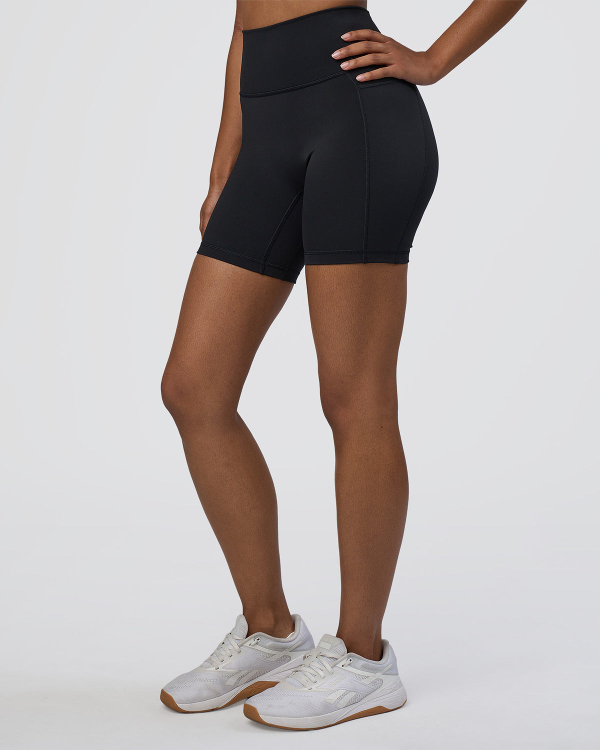 Woman wearing Fusion Ultra High-Rise 6" Short Pockets - Black | Set:true | Angle:side | Model:Jordan | Size:S