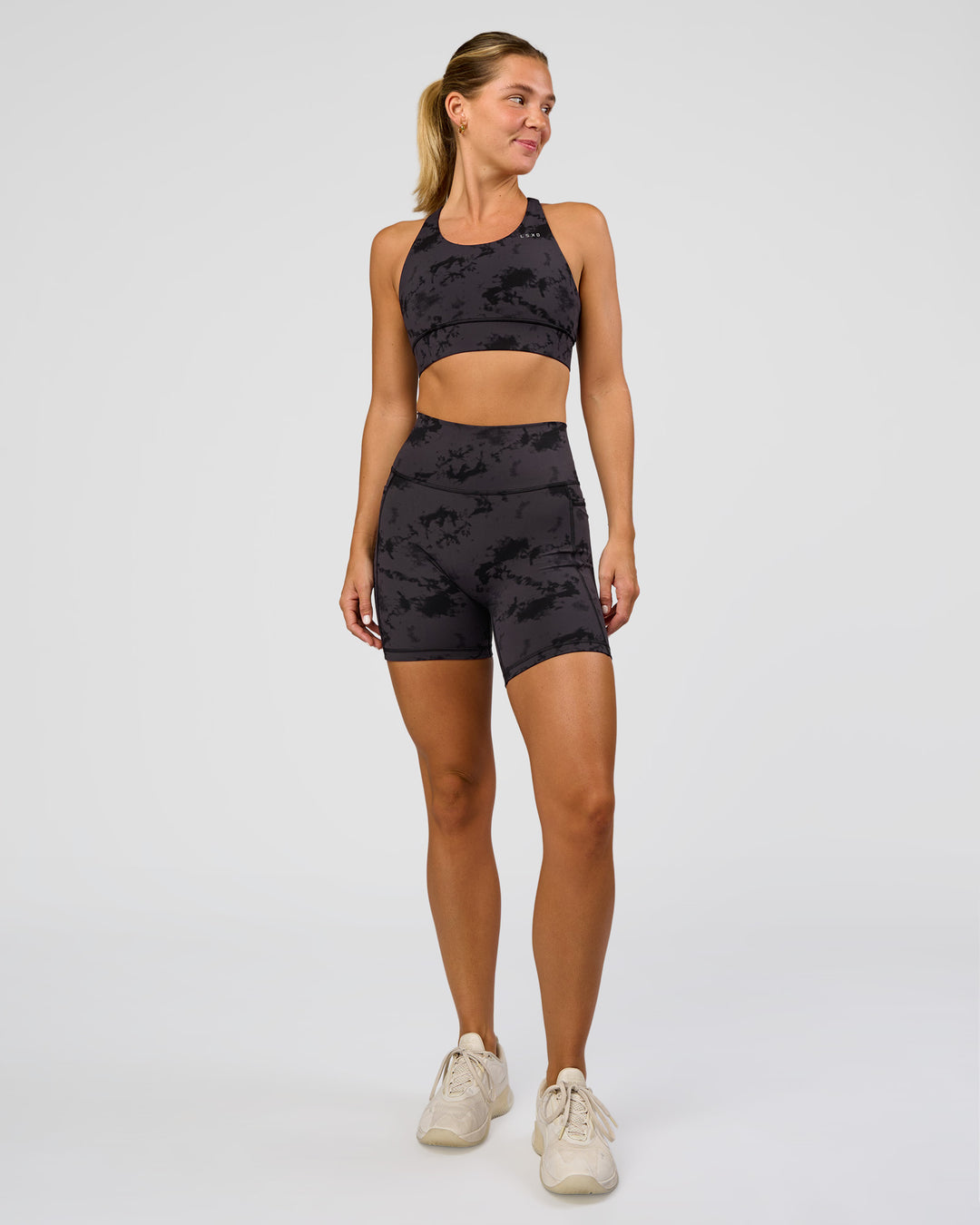 Woman wearing Fusion Ultra High-Rise 6" Short Pockets - Black Tie Dye | Model:Amity | Size:S - view 3