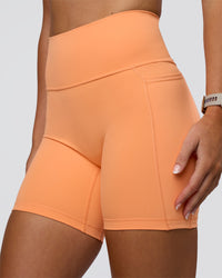 Woman wearing Fusion Ultra High-Rise 6" Short Pockets - Cantaloupe | Model:Emelia | Size:S | Thumbnail Index: 5