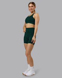 Woman wearing Fusion Ultra High-Rise 6" Short Pockets - Dark Moss | Model:Emilie | Size:S | Thumbnail Index: 1
