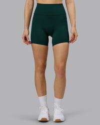 Woman wearing Fusion Ultra High-Rise 6" Short Pockets - Dark Moss | Model:Emilie | Size:S | Thumbnail Index: 0