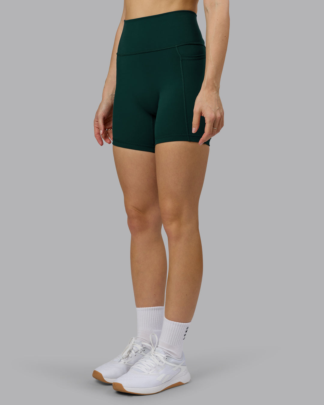Woman wearing Fusion Ultra High-Rise 6" Short Pockets - Dark Moss | Model:Emilie | Size:S - view 6