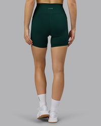 Woman wearing Fusion Ultra High-Rise 6" Short Pockets - Dark Moss | Model:Emilie | Size:S | Thumbnail Index: 3