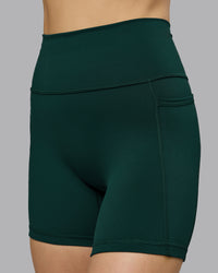 Woman wearing Fusion Ultra High-Rise 6" Short Pockets - Dark Moss | Model:Emilie | Size:S | Thumbnail Index: 2
