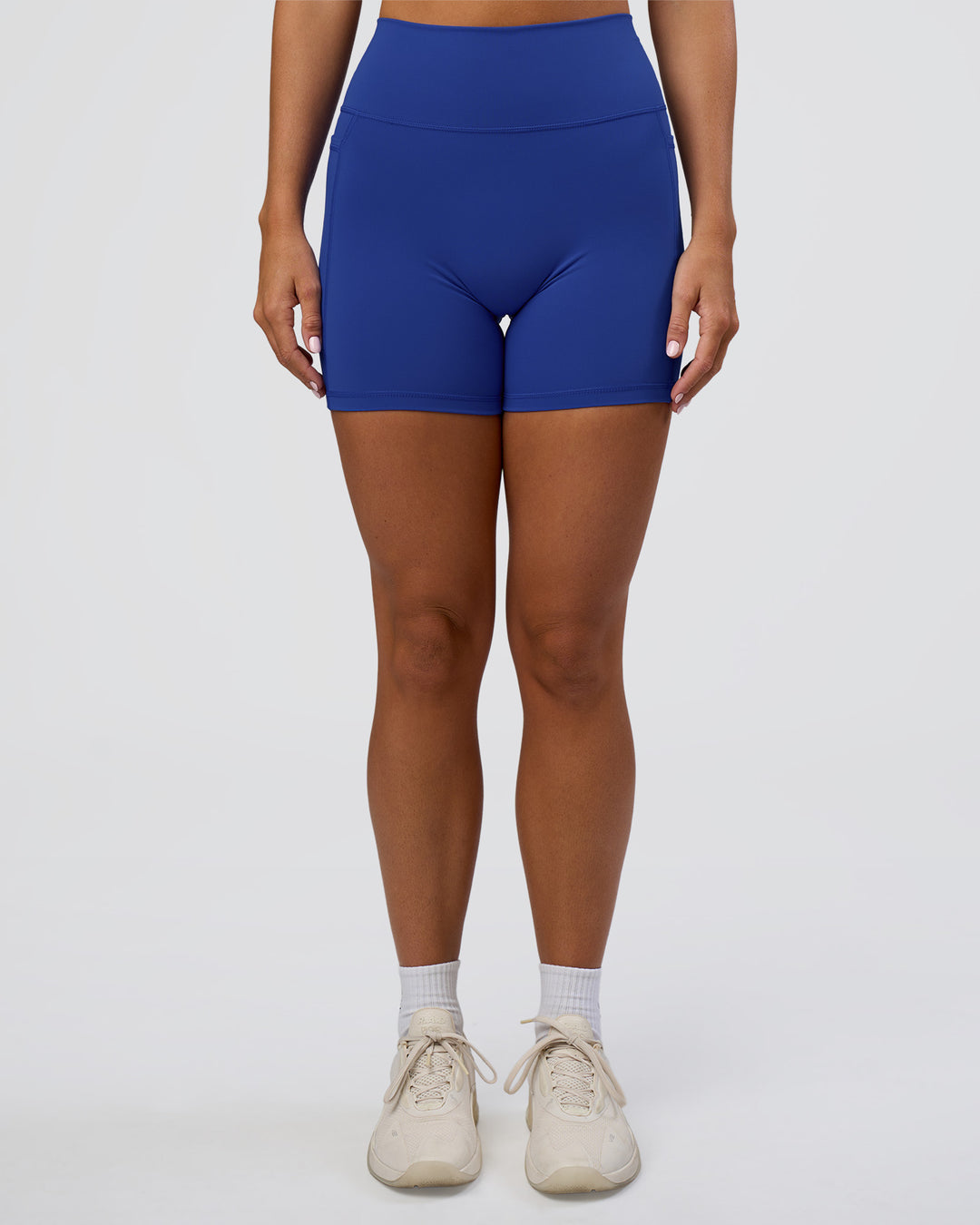 Woman wearing Fusion Ultra High-Rise 6" Short Pockets - Electric Indigo | Set:true | Angle:front | Model:Amity | Size:S - view 7