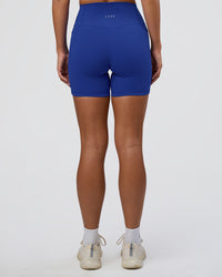 Woman wearing Fusion Ultra High-Rise 6" Short Pockets - Electric Indigo | Set:true | Angle:back | Model:Amity | Size:S | Thumbnail Index: 3