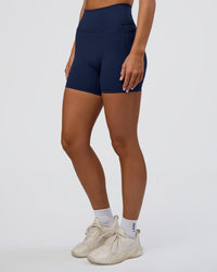 Woman wearing Fusion Ultra High-Rise 6" Short Pockets - Future Navy | Set:true | Angle:side | Model:Amity | Size:S | Thumbnail Index: 0