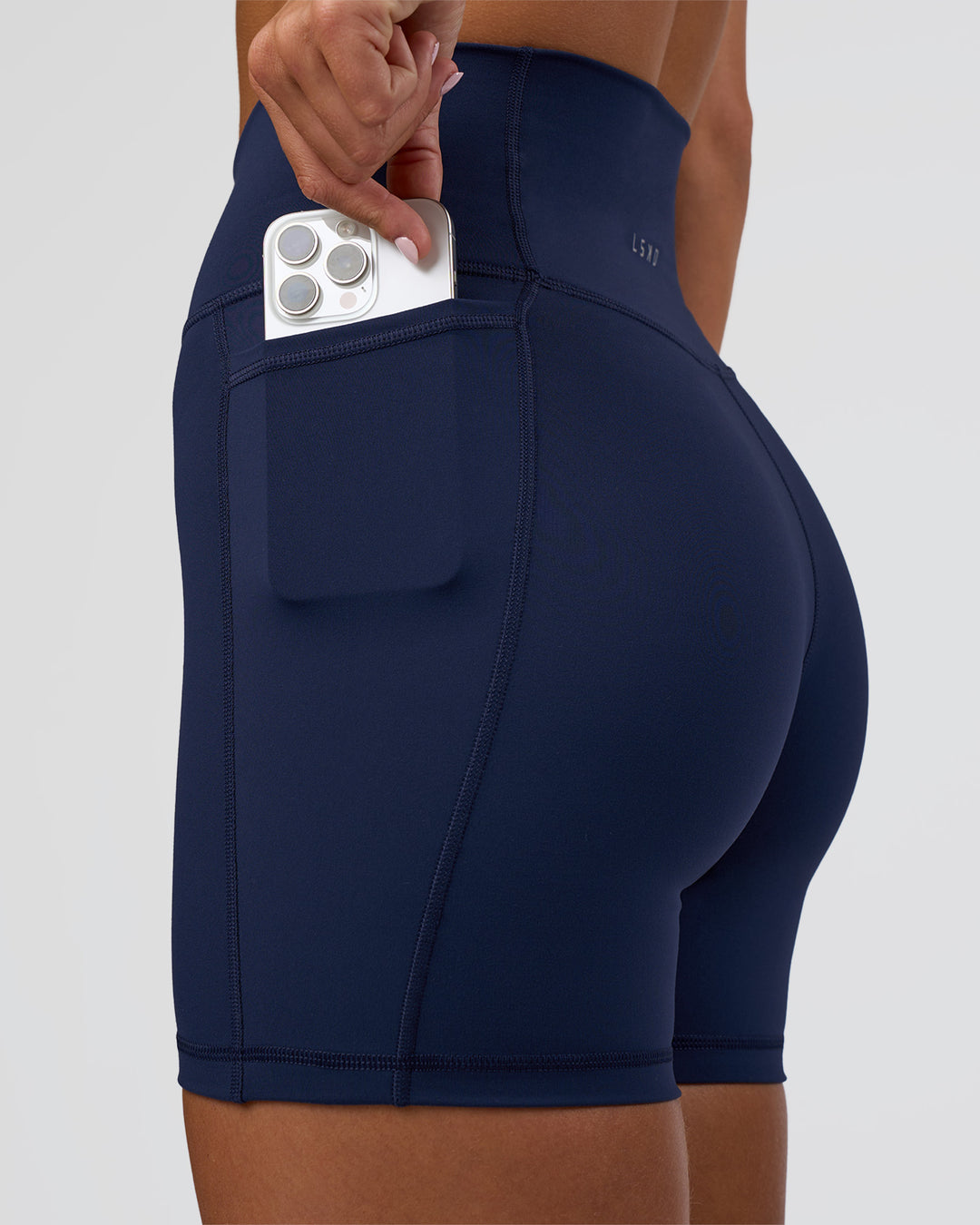 Woman wearing Fusion Ultra High-Rise 6" Short Pockets - Future Navy | Set:true | Angle:closeup | Model:Amity | Size:S - view 3