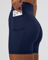 Woman wearing Fusion Ultra High-Rise 6" Short Pockets - Future Navy | Set:true | Angle:closeup | Model:Amity | Size:S | Thumbnail Index: 2
