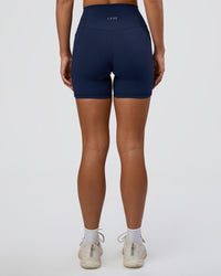 Woman wearing Fusion Ultra High-Rise 6" Short Pockets - Future Navy | Set:true | Angle:back | Model:Amity | Size:S | Thumbnail Index: 3
