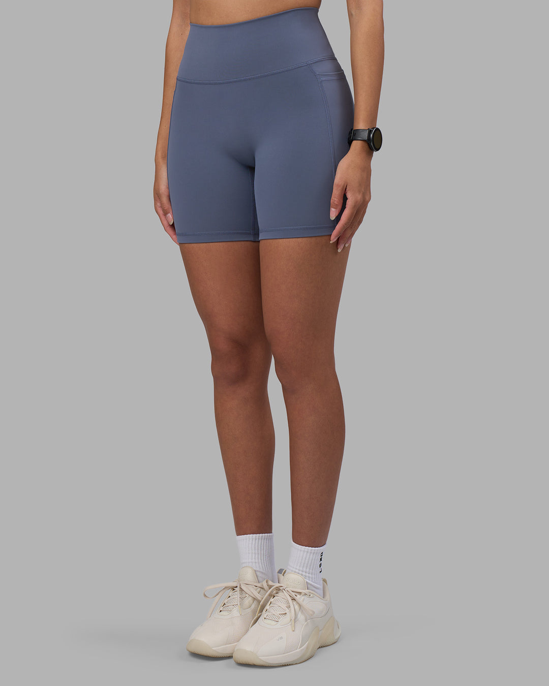Woman wearing Fusion Ultra High-Rise 6" Short Pockets - Night Shadow | Set:true | Angle:side | Model:Rhiley | Size:S - view 7